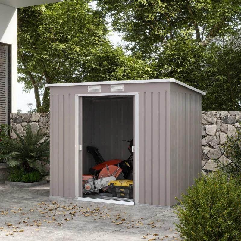 Grey outdoor metal storage shed with double doors open, vented panels and sloped roof