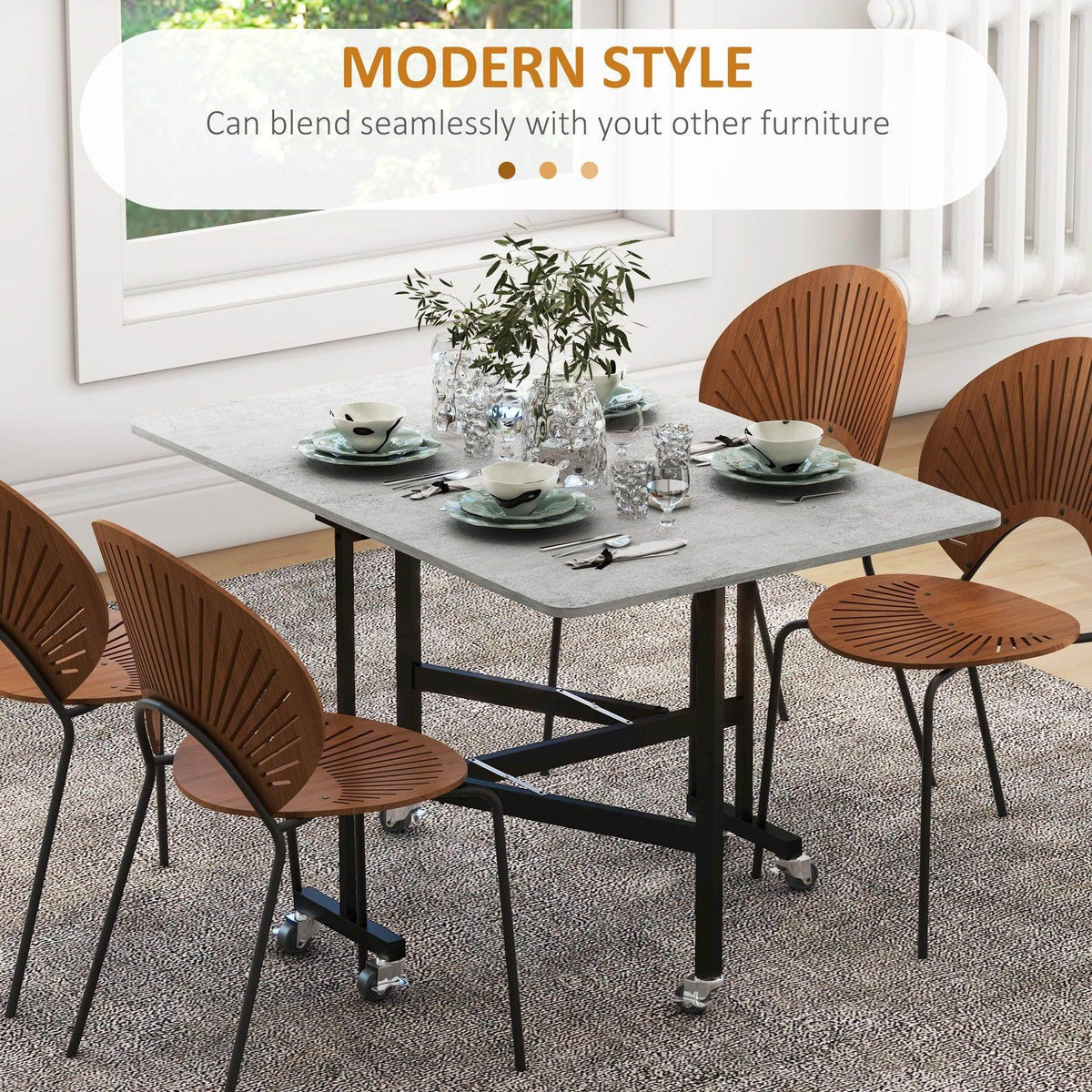 Grey drop-leaf folding dining table with black frame and rolling caster feet