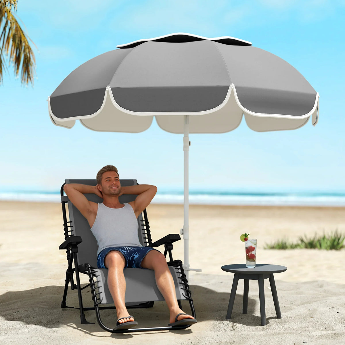 Grey beach umbrella with tilted canopy and scalloped shade panels