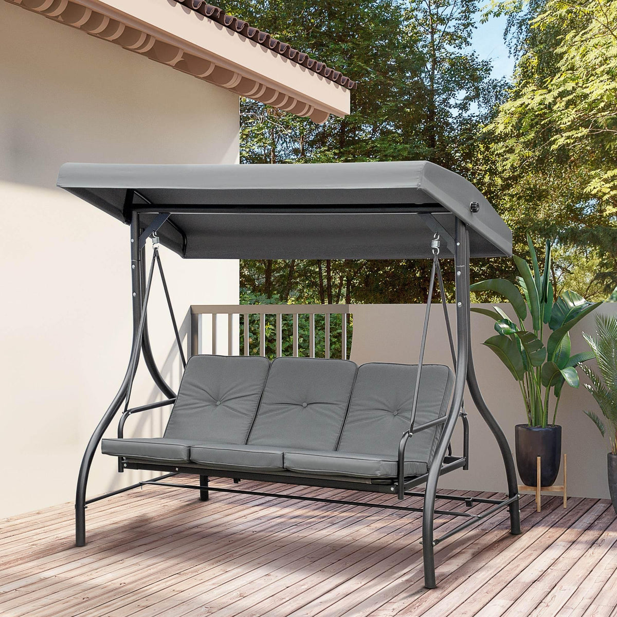 Dark grey 3-person swing bed with adjustable canopy and padded bench cushions on patio