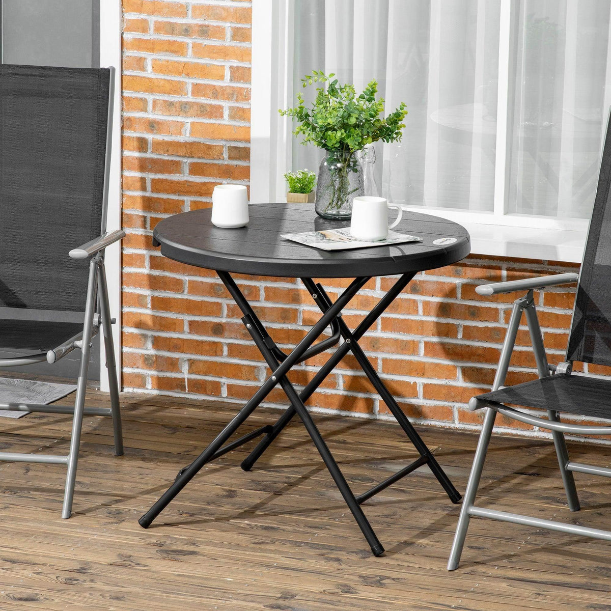 Foldable round garden dining table with dark tabletop and black X-style steel legs
