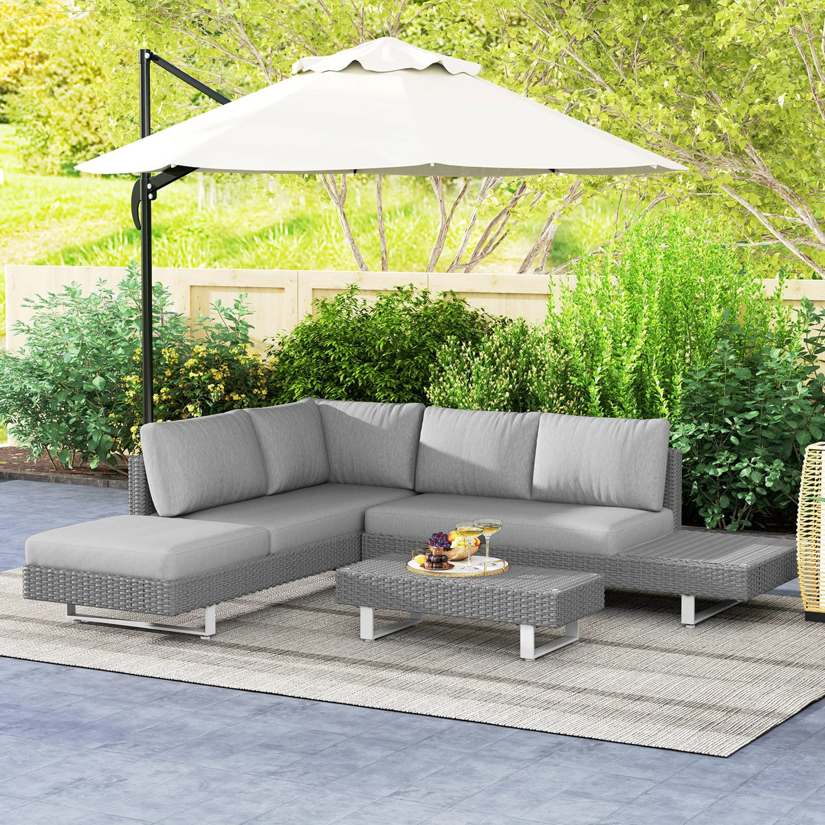 Light-grey outdoor rattan sectional sofa set with padded cushions and coffee table