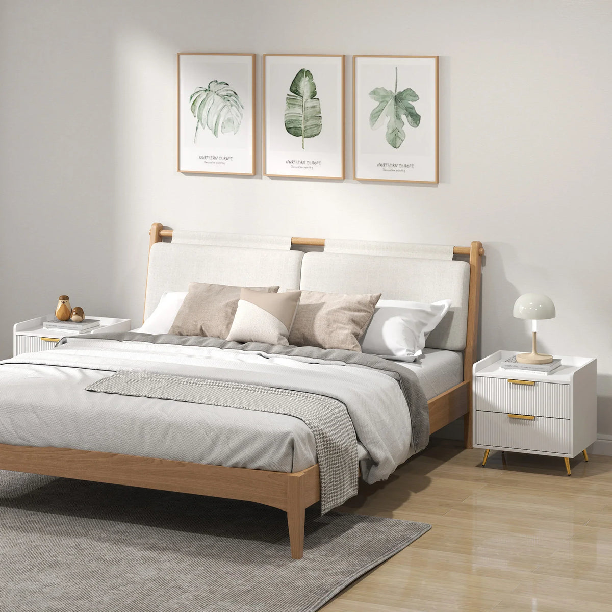 White bedside table set with ridged drawer fronts and gold-tone handles beside a bed
