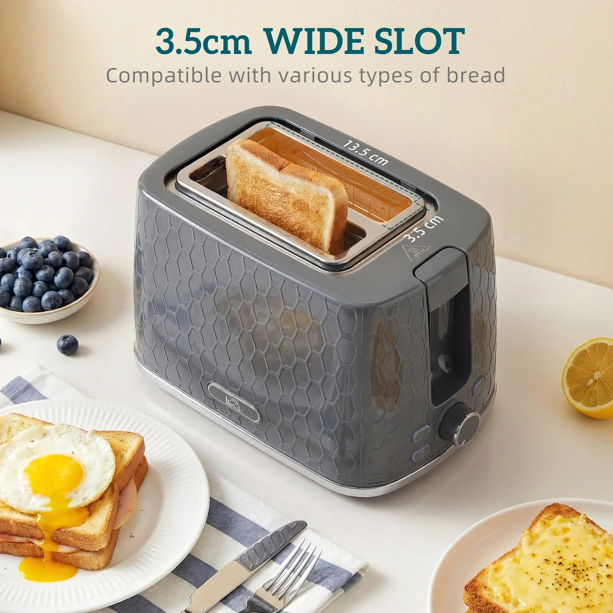 Grey 2-slice toaster with wide slot and toast slices on a countertop.