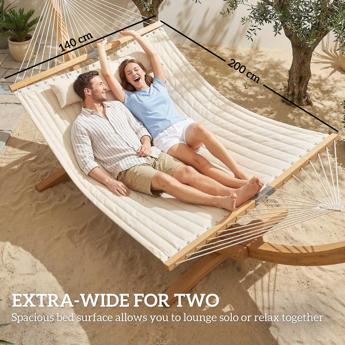 Extra-wide double cream hammock with stand, spreader bars, and two people relaxing