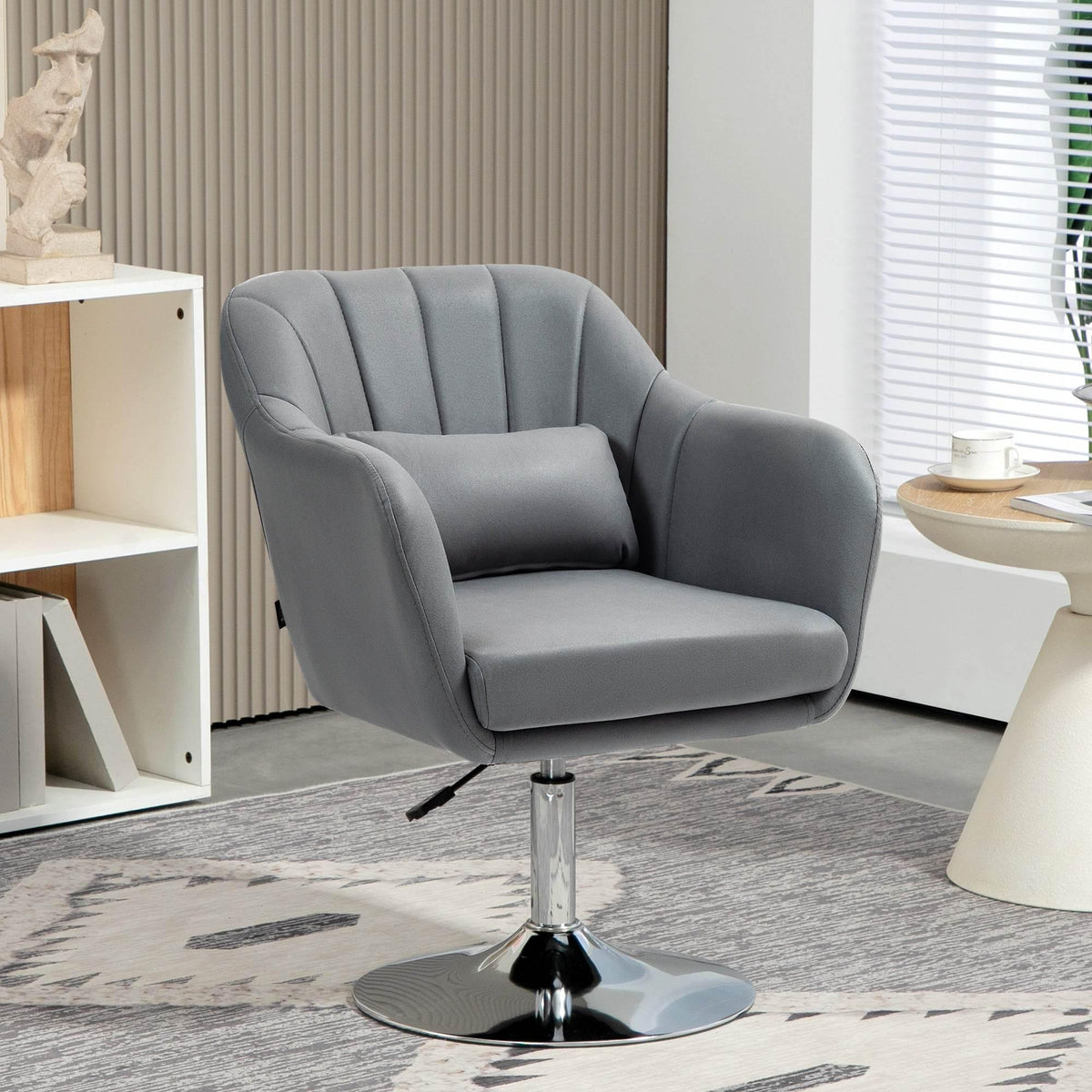 Grey upholstered accent armchair with curved arms and thick seat cushion