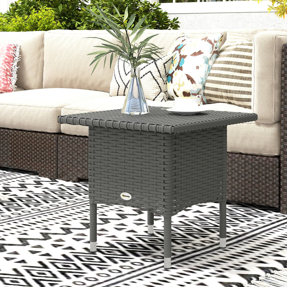 Grey woven rattan side table with square tabletop and four slender legs