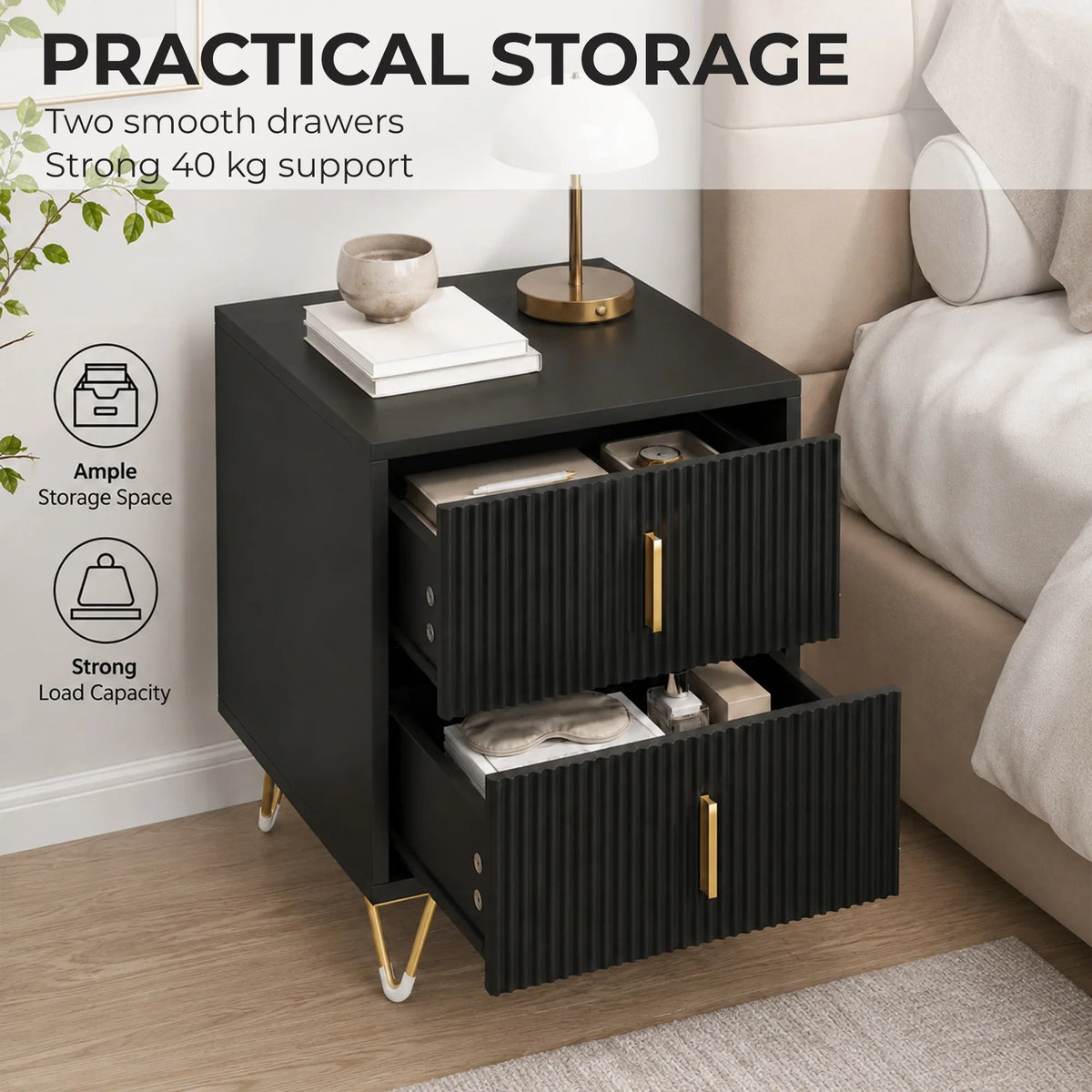 Black fluted bedside table with two open drawers and gold bar handles on gold legs