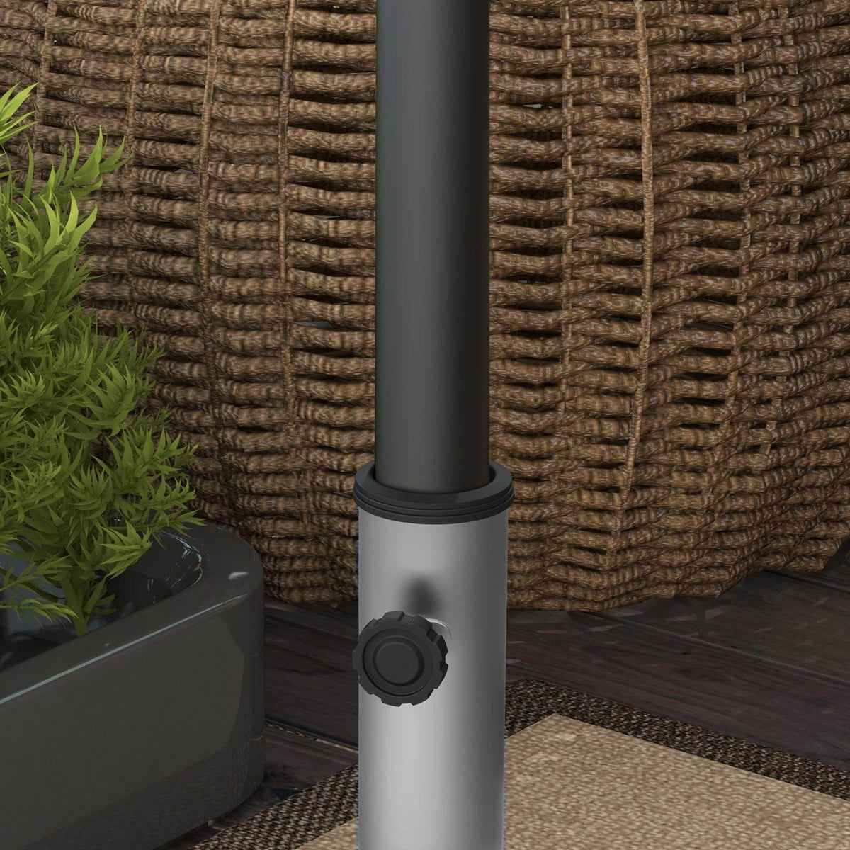 Close-up of grey umbrella stand tube with securing knob on granite square base.