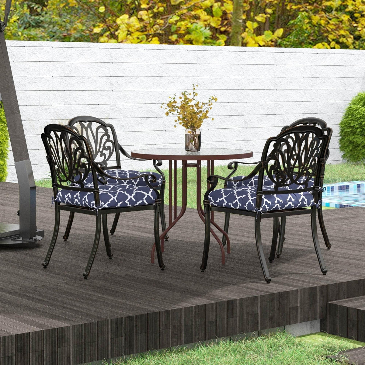 Two navy blue patio chair cushions with white geometric pattern and tied seat pads