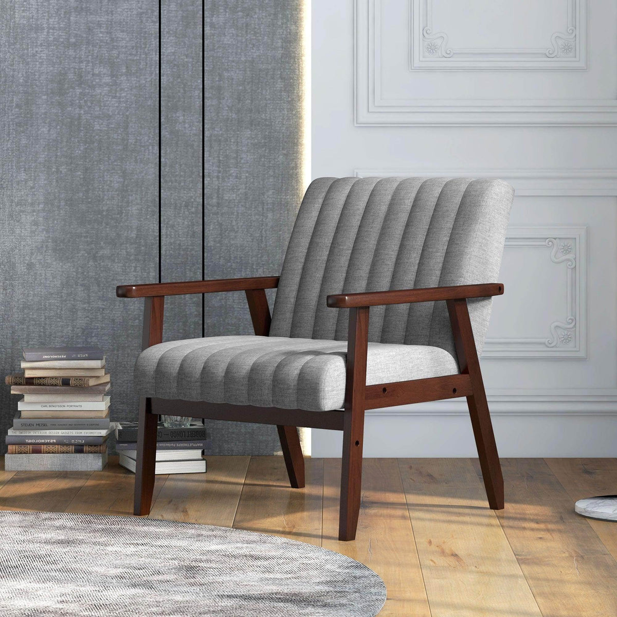 Grey fabric accent armchair with vertical tufting, curved arms, and dark wood legs