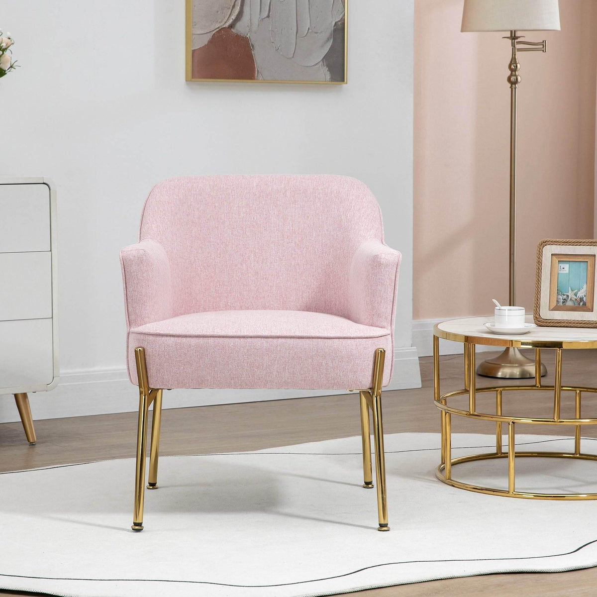 Pink upholstered accent chair with gold legs, front view