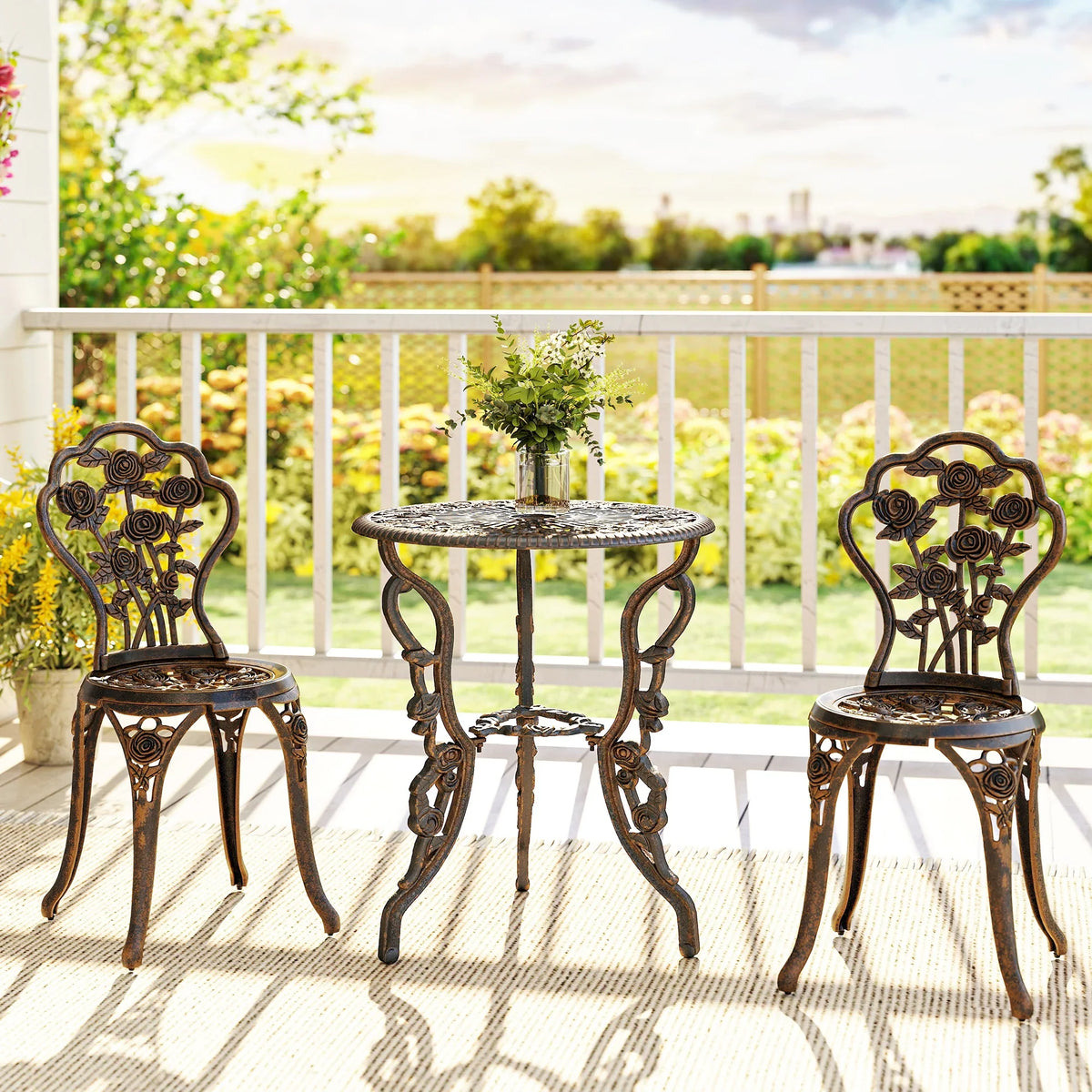 Bronze outdoor bistro set with round table and two ornate chairs, cast metal vintage style.