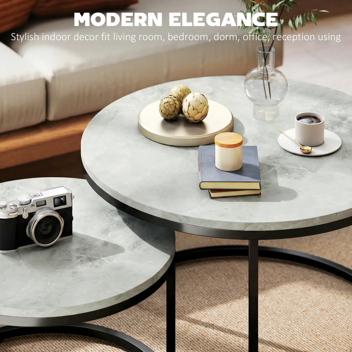 Round grey marble-effect nesting table set with black legs in a living room