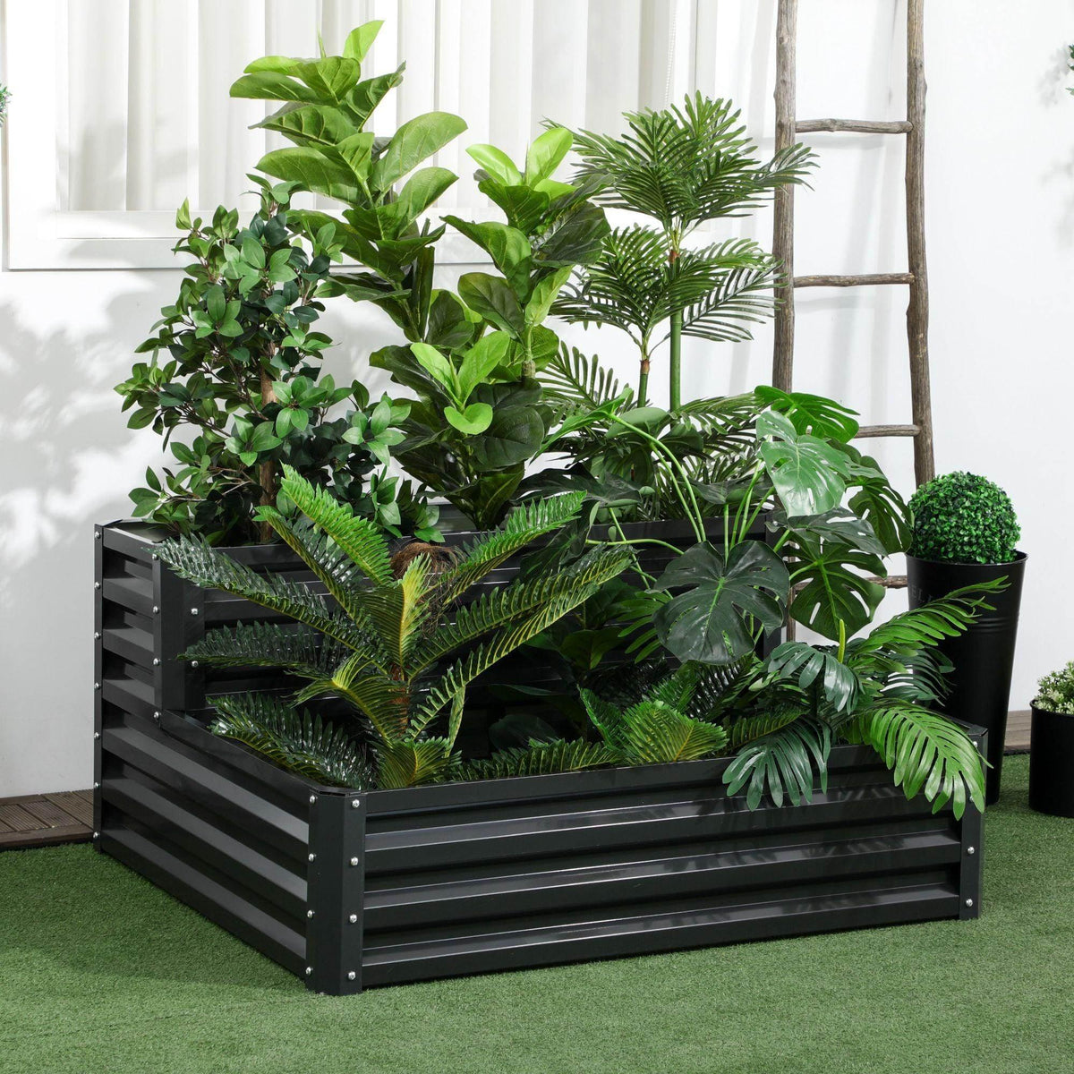 Dark gray two-tier raised garden planter with open slat sides, filled with soil and plants