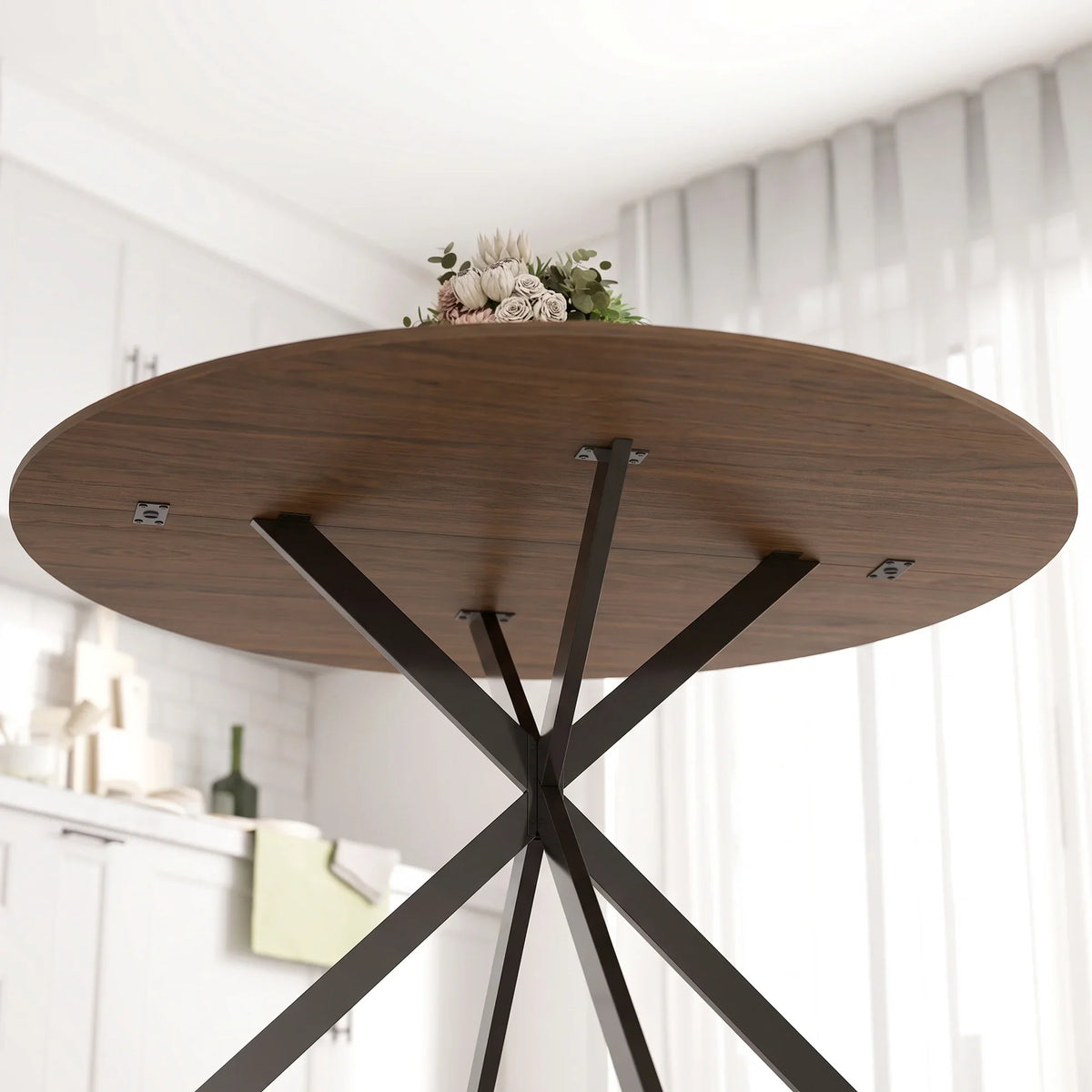 Round dining table with brown wood-effect top and black cross steel leg frame.