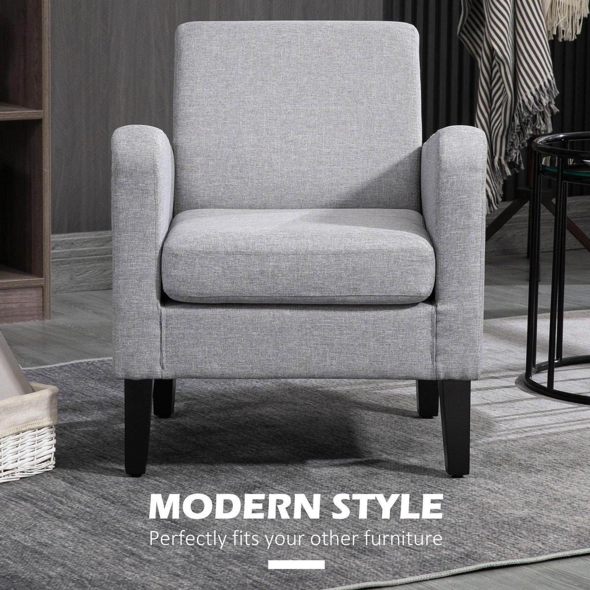 Light grey armchair with tall backrest, rounded arms, and black legs