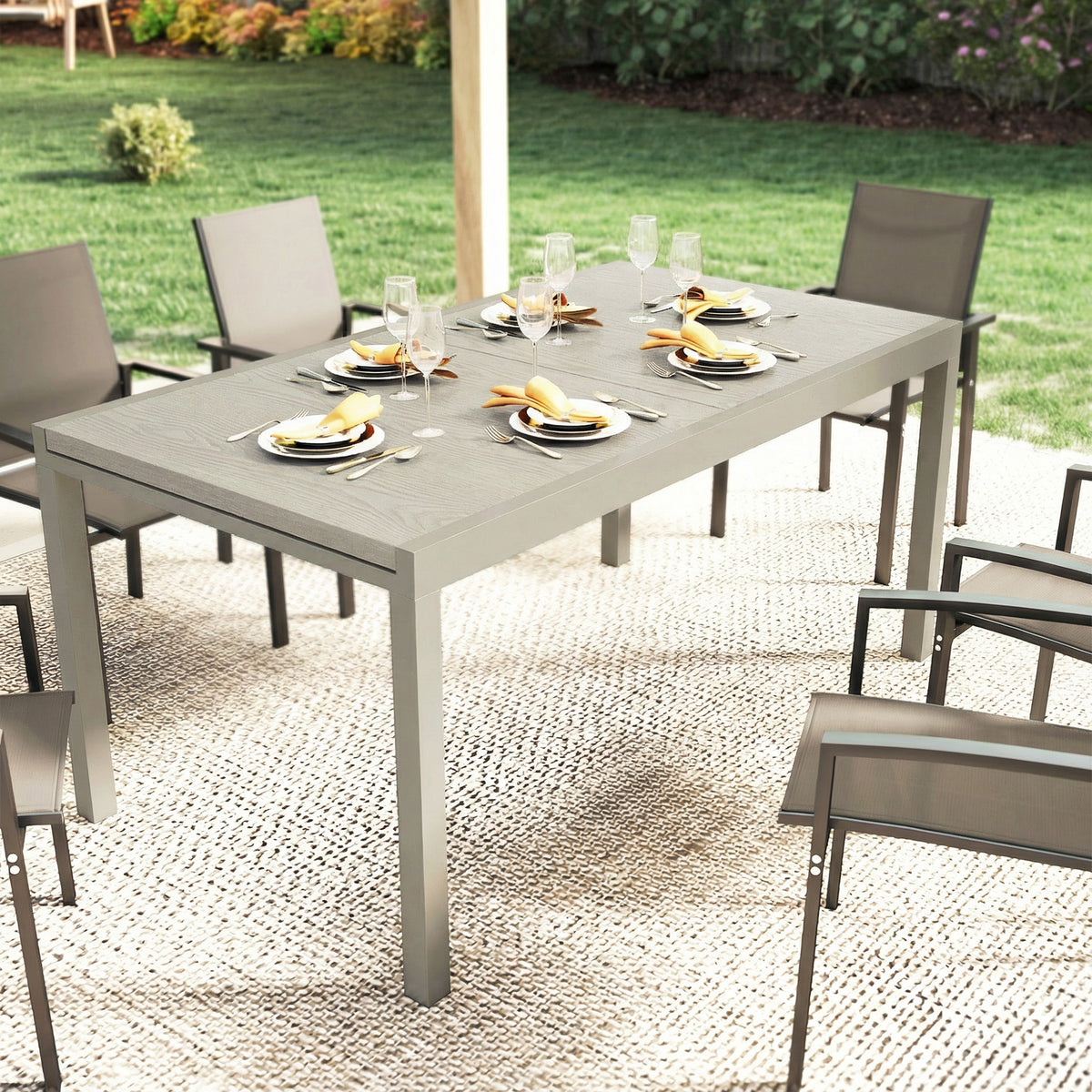 Light grey outdoor dining table with wood-look top and dining set