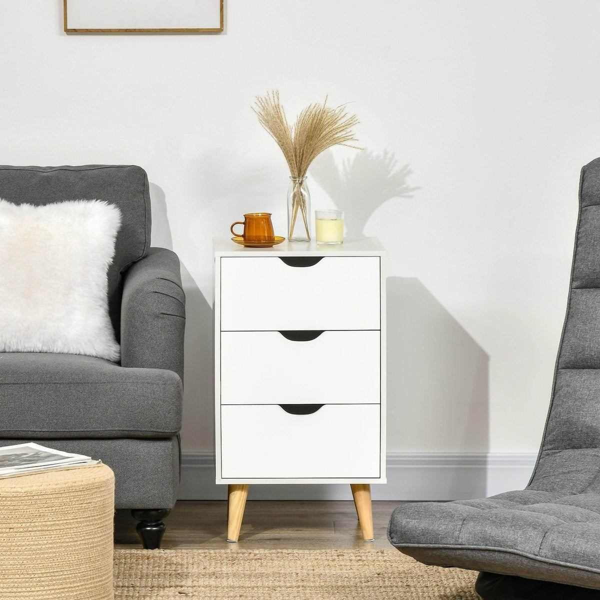 White 3-drawer storage chest with black curved handles and light wood legs