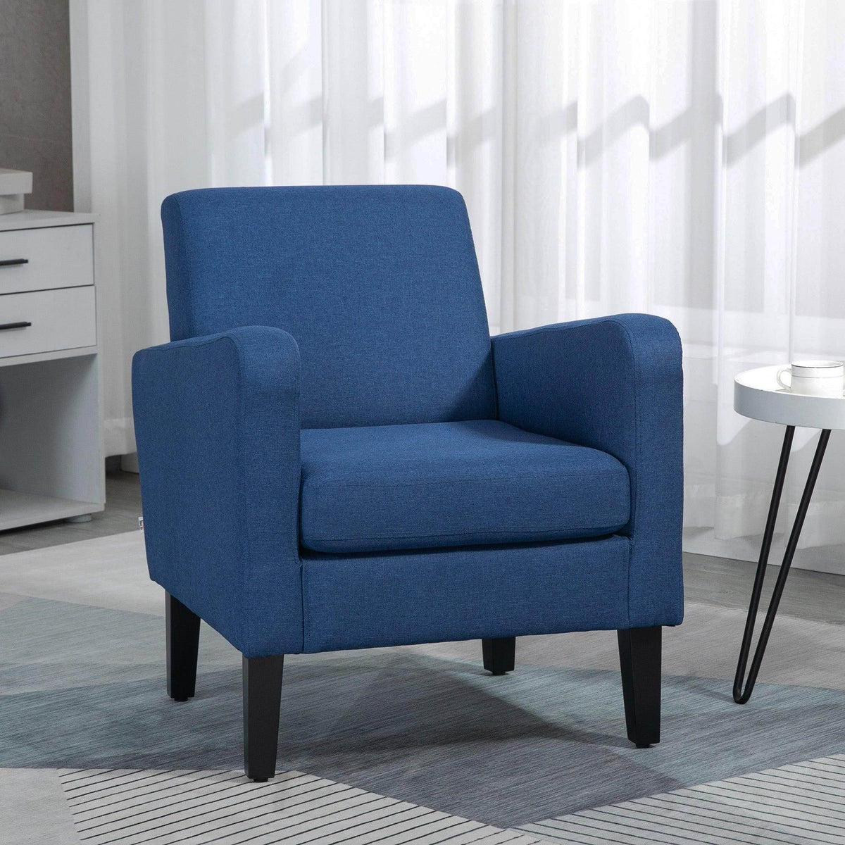 Blue upholstered accent armchair with padded armrests and dark wood legs.