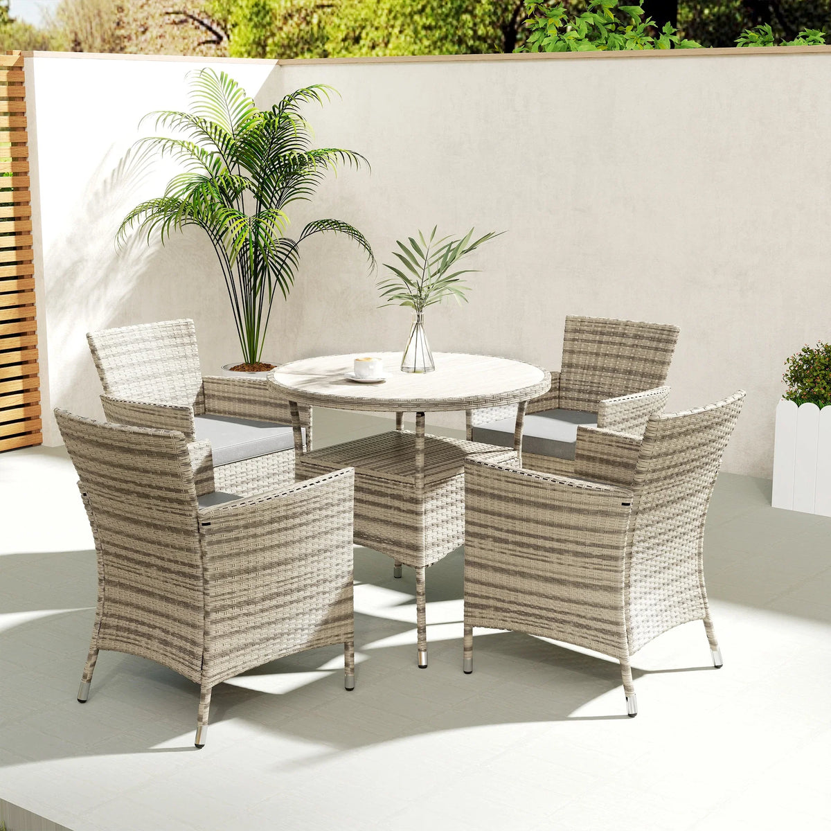 Grey rattan outdoor dining set with four armchairs and round two-tier table, patio yard