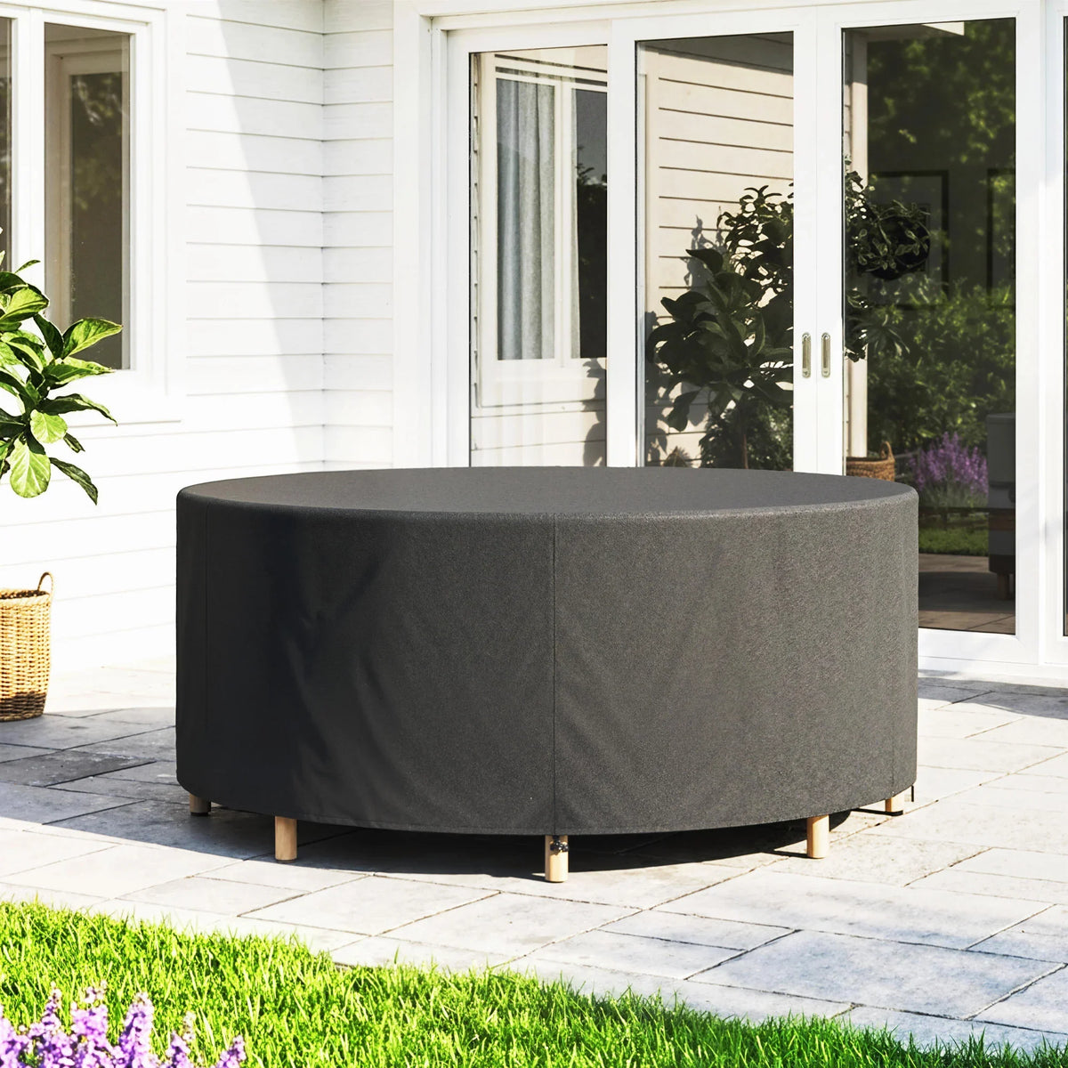 Black round outdoor furniture cover with fitted skirt and hem over table legs