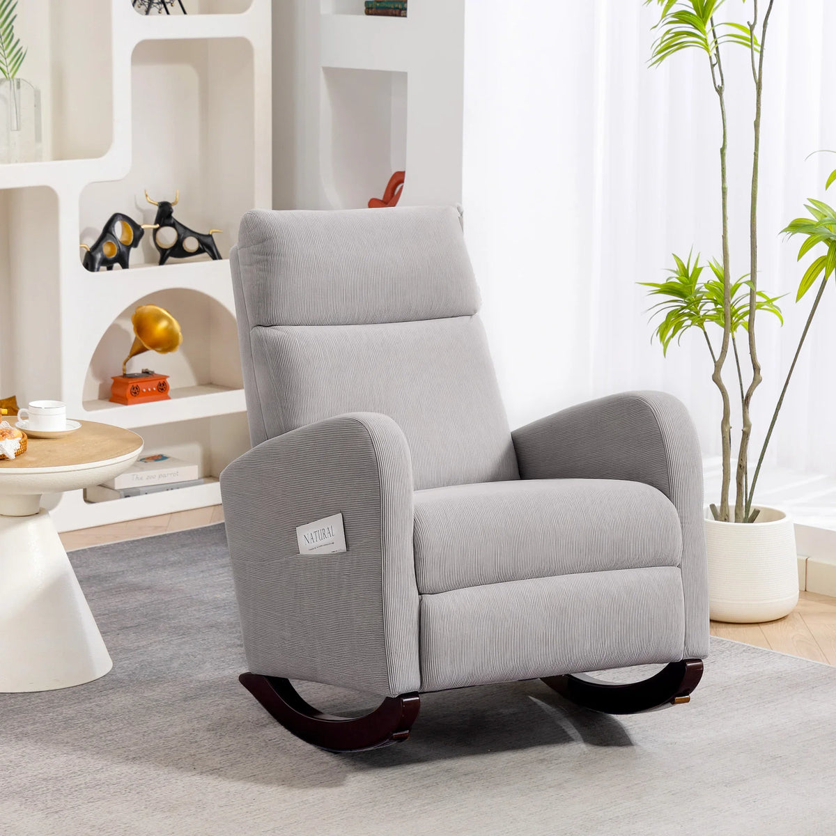Grey corduroy rocking armchair with plush backrest and curved rocking base
