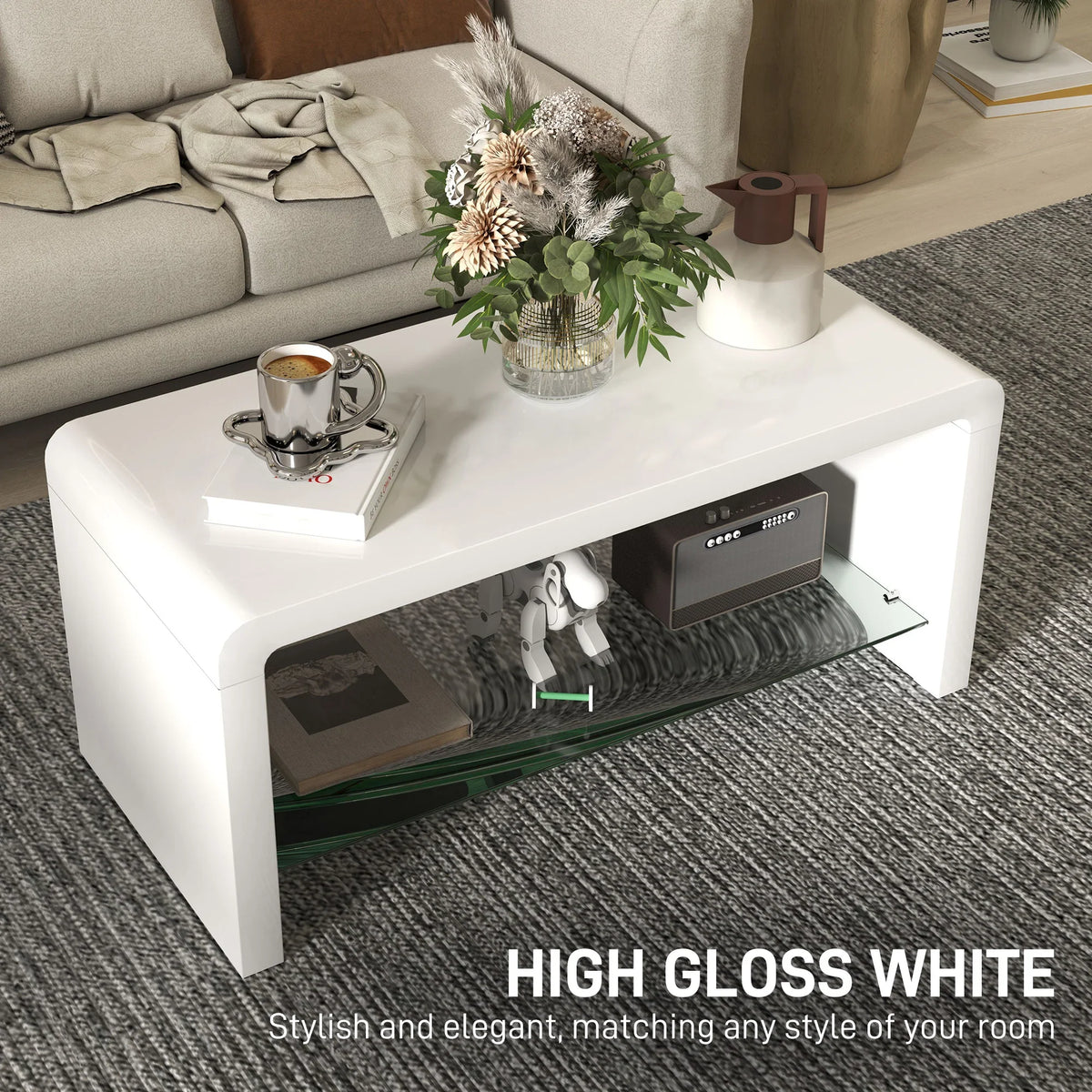 High-gloss white curved coffee table with top surface and open lower glass storage shelf