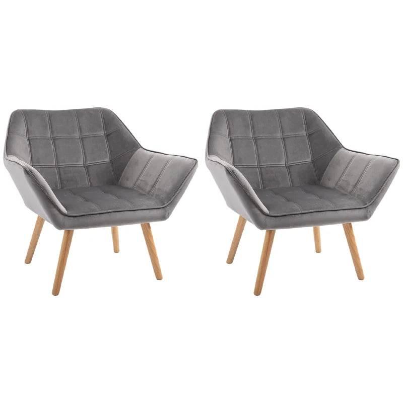 Pair of grey upholstered armchairs with wide arms and rubber wood legs, tufted design