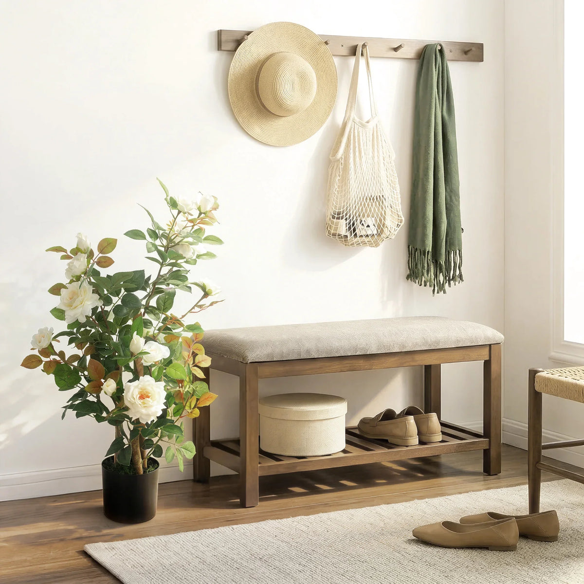 Artificial rose tree with white flowers and green foliage in black pot on wood floor