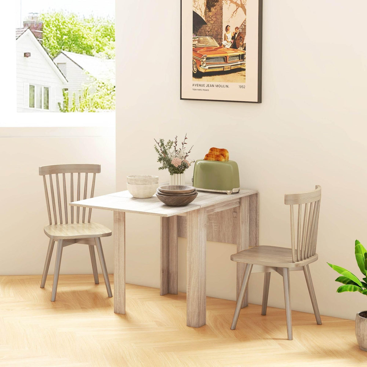 Light oak drop-leaf dining table with four chairs, matching light wood finish dining nook