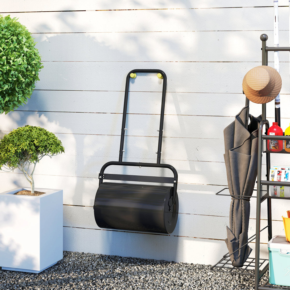 Black steel lawn roller with U-handle and rounded cylinder for outdoor use