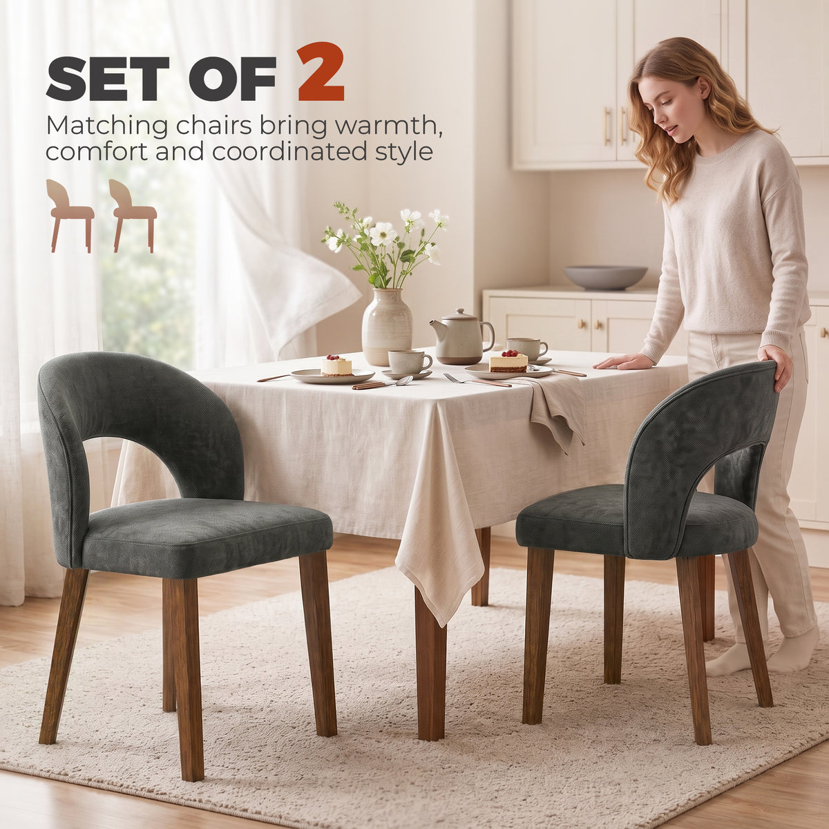 Set of 2 dark grey upholstered dining chairs with arched backs and wooden legs