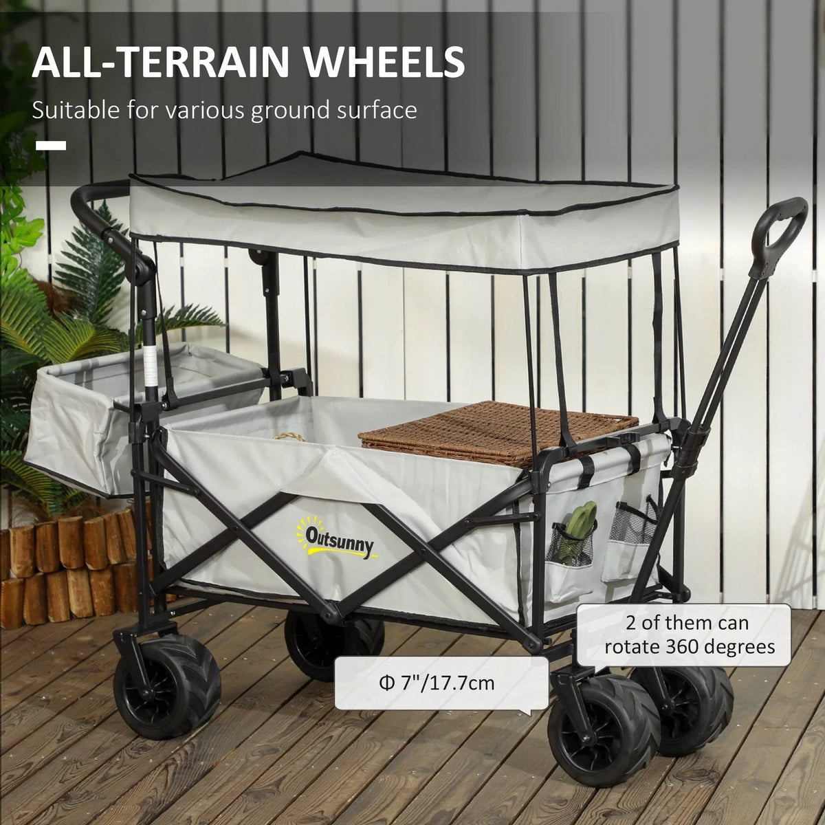Grey folding beach wagon with all-terrain wheels and two cup holders, canopy included.