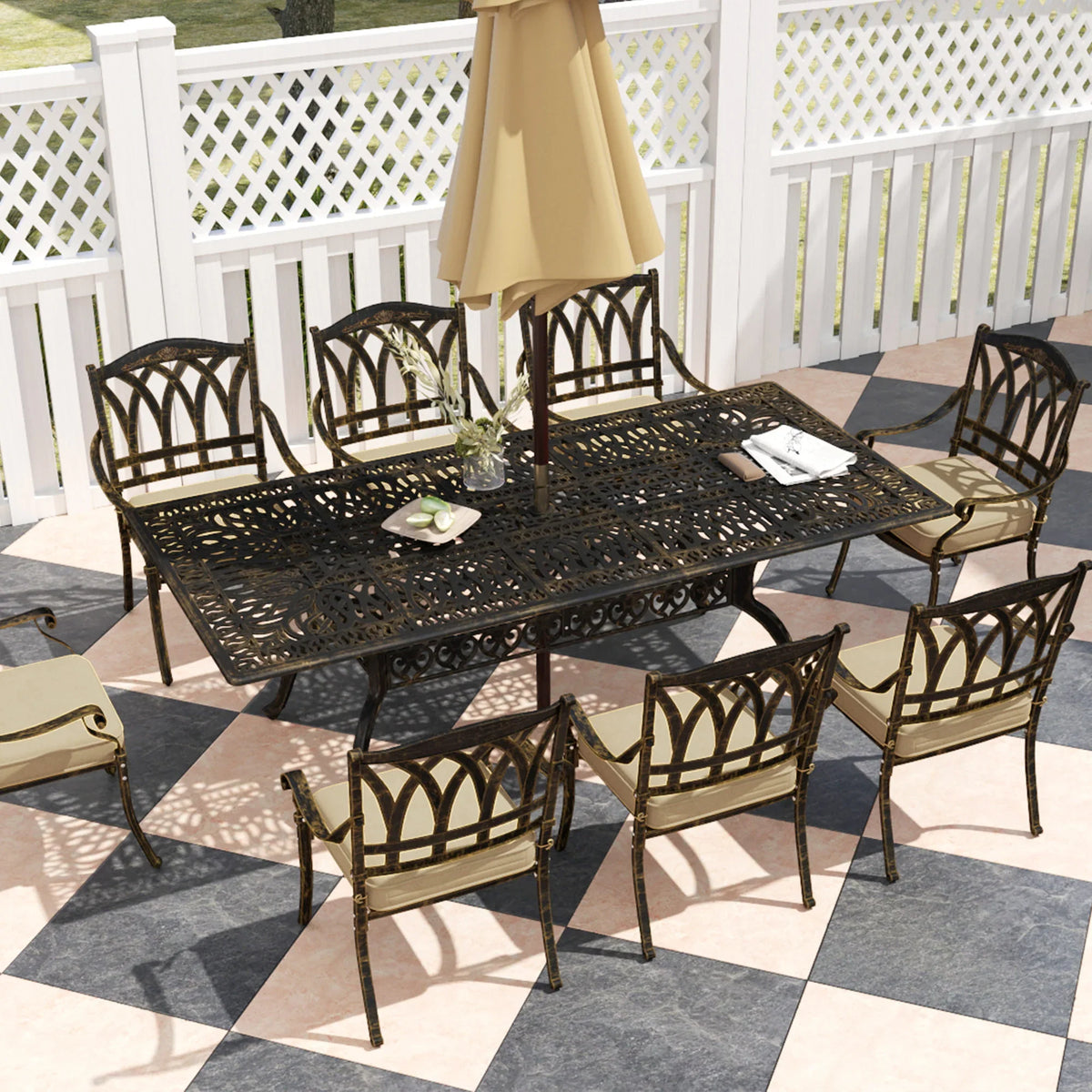 Bronze-tone outdoor dining set with perforated tabletop and arched-back chairs with seat cushions