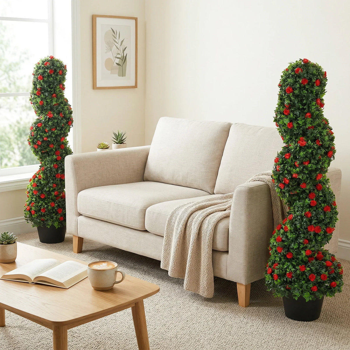 Pair of spiral artificial rose topiary trees in black pots, red flowers on green foliage