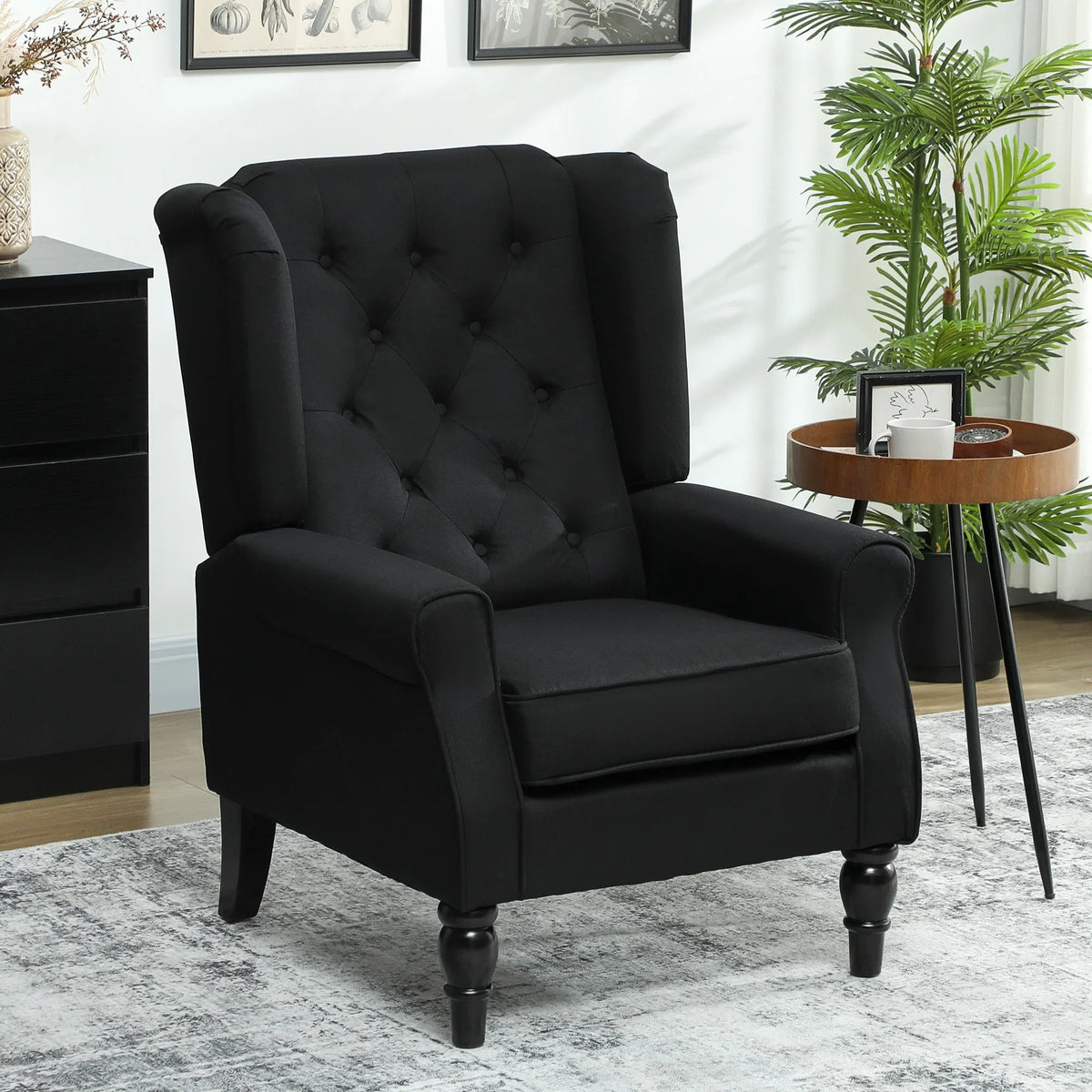Black wingback accent armchair with tufted back, button detailing, and rolled arms