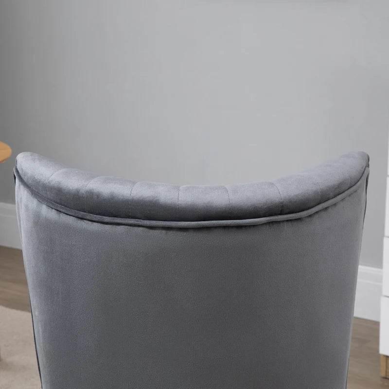 Grey velvet accent chair back with curved top and padded seam detailing