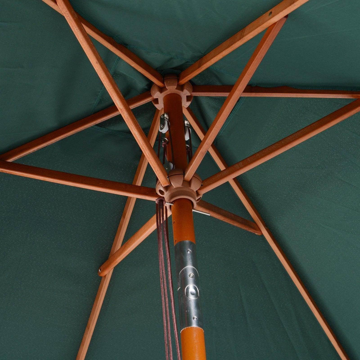 Patio umbrella frame with cross wooden ribs and dark green canopy fabric