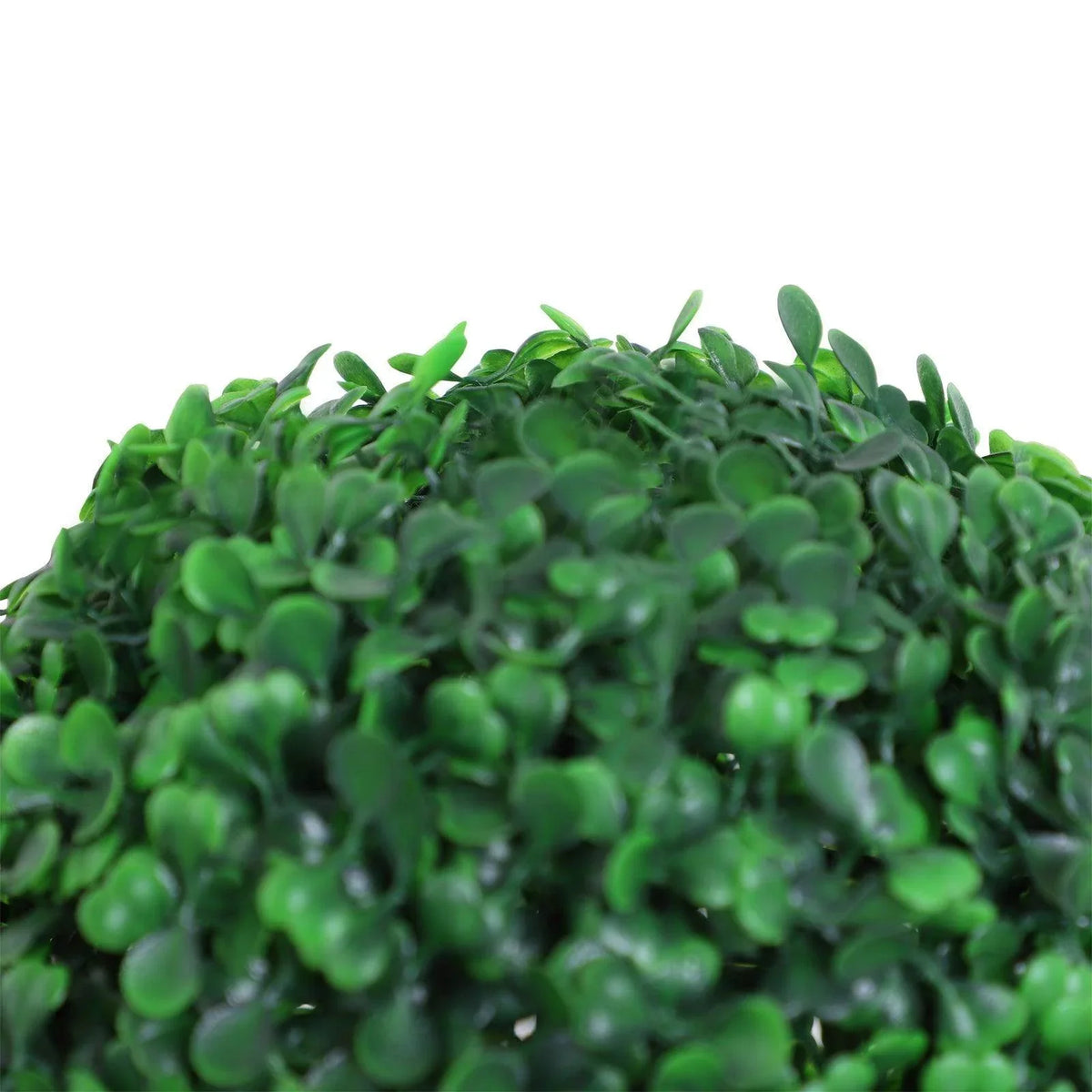 Close-up of artificial boxwood ball topiary leaves in bright green