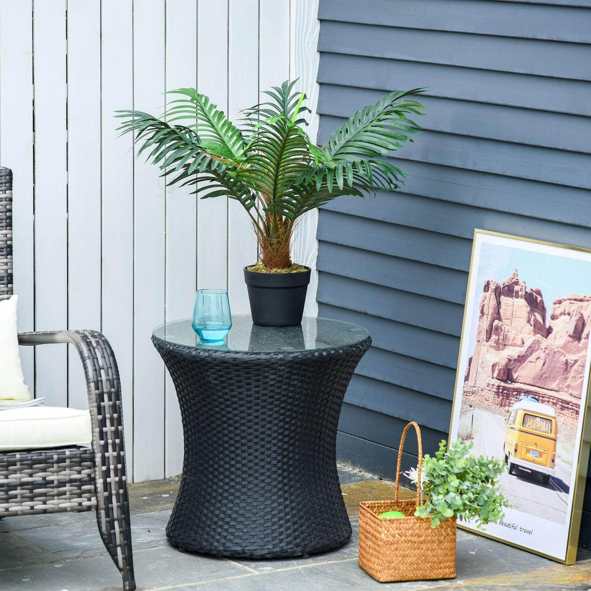 Artificial palm tree in black textured pot with green fronds and brown trunk