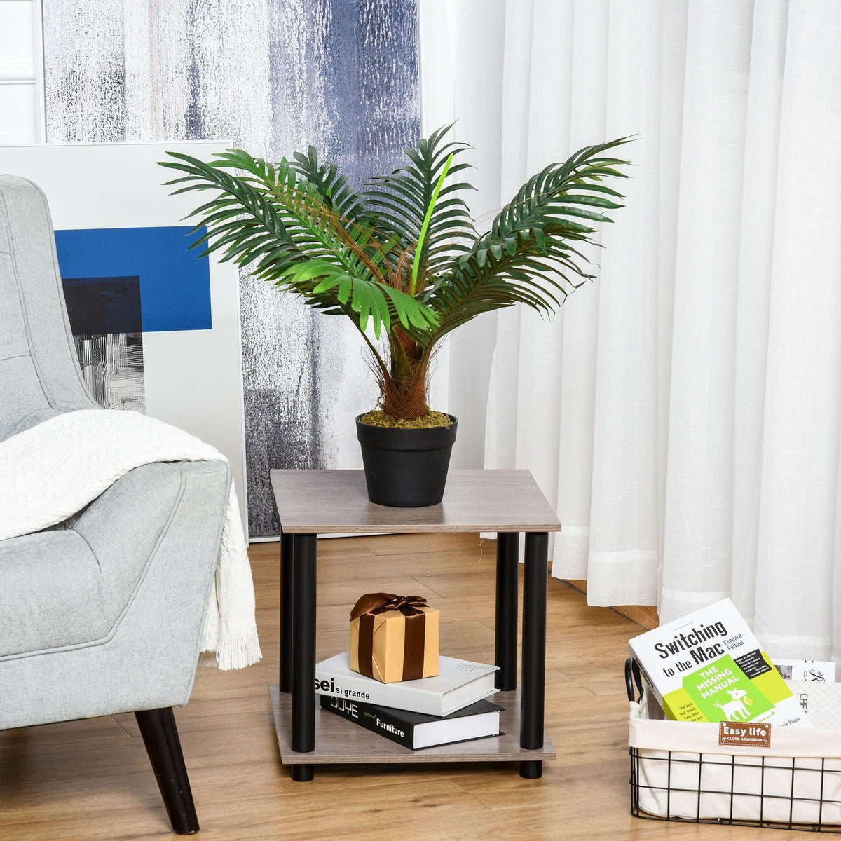 Artificial palm tree in black pot on wooden stand, green fronds