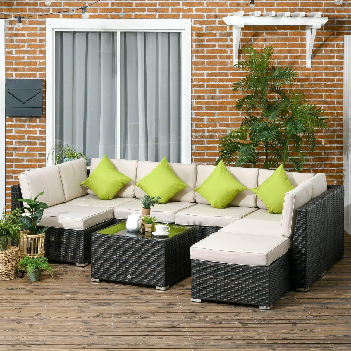 Outdoor wicker sofa set with black frames, white cushions, and lime green pillows