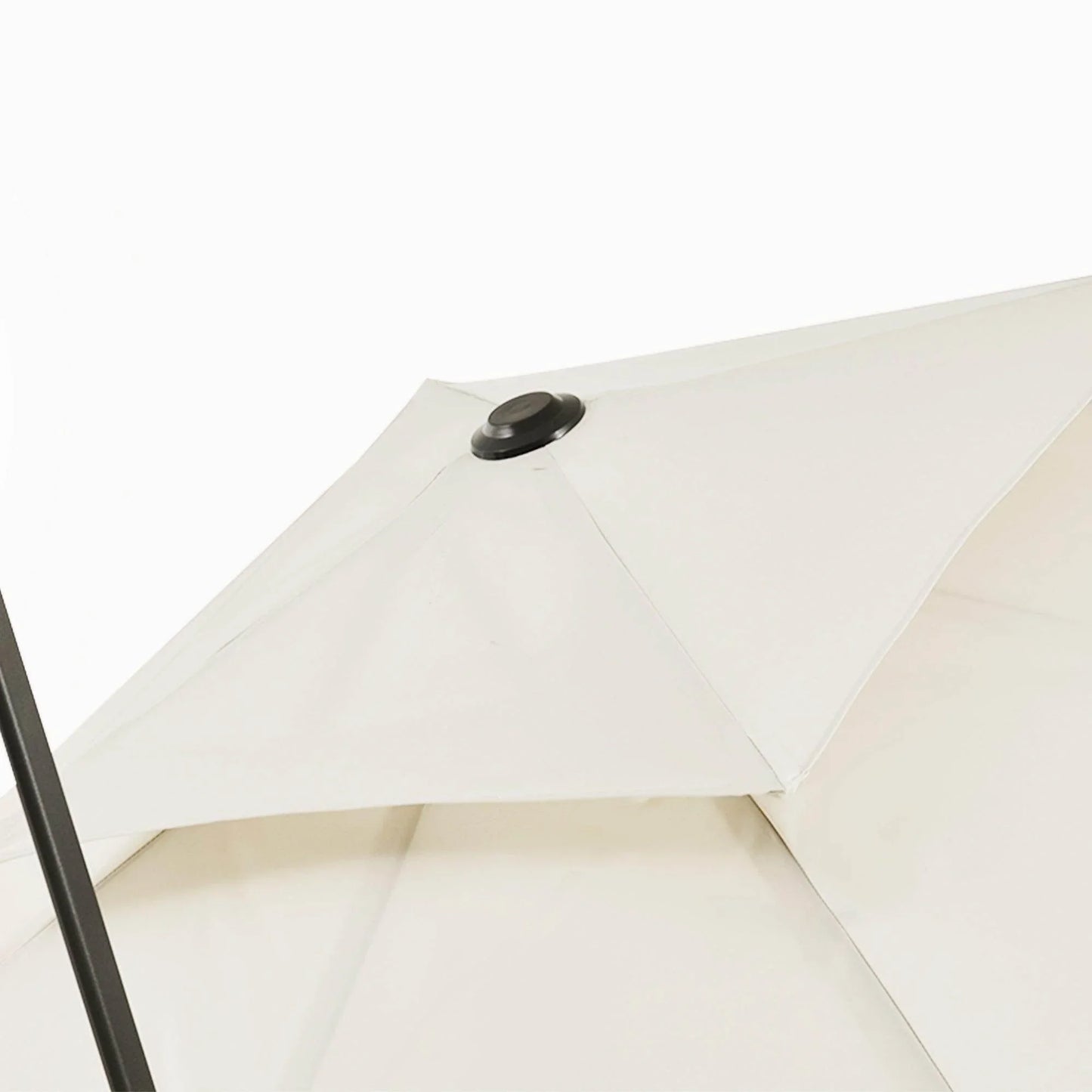 Beige square umbrella canopy close-up with top button and folded panel seams