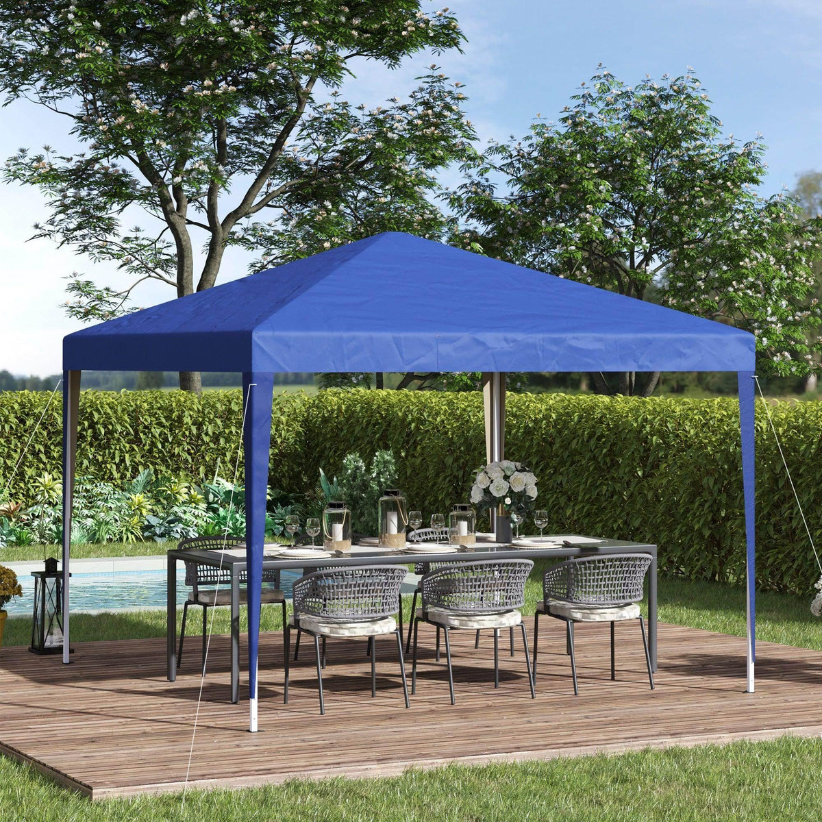 Blue pop-up garden gazebo with open sides and steel posts over a wooden deck