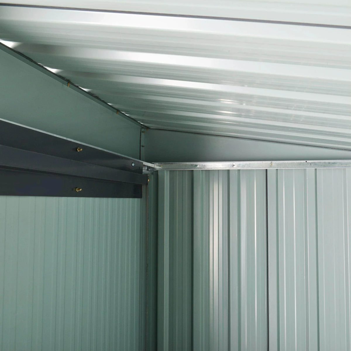 Metal shed interior with corrugated wall panels and sloped roof support