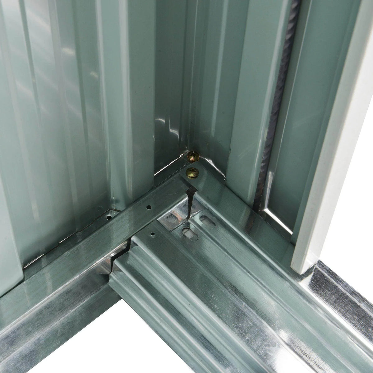 Metal shed interior corner with raised floor panels and door track