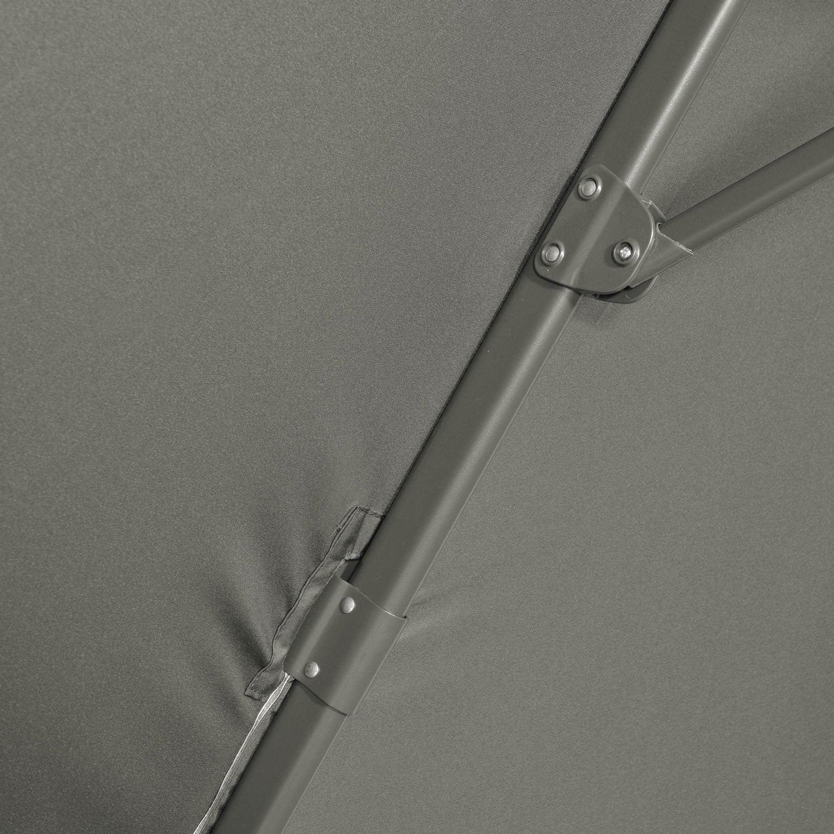 Close-up of grey umbrella canopy seam with metal rib fasteners