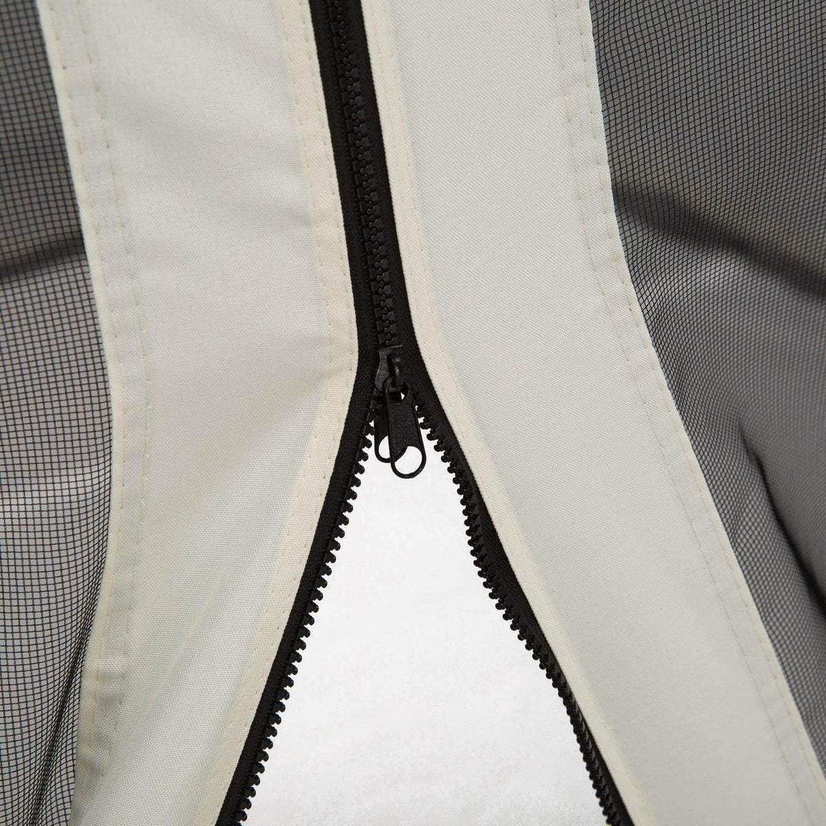 Close-up of black zipper on white mesh gazebo curtain