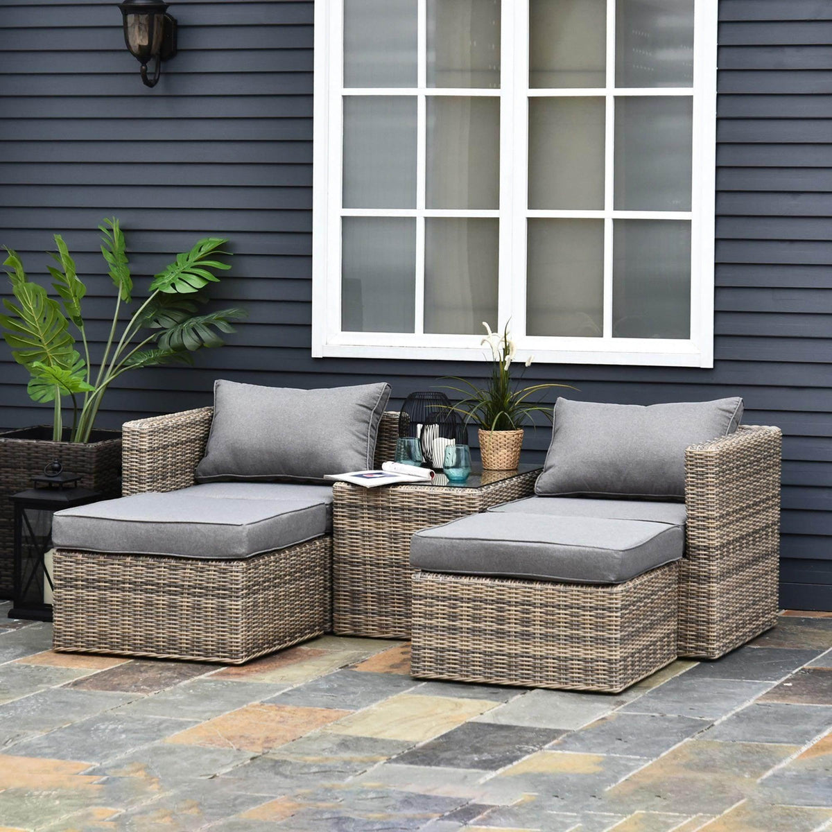 Grey outdoor rattan sofa set with cushions and woven side table